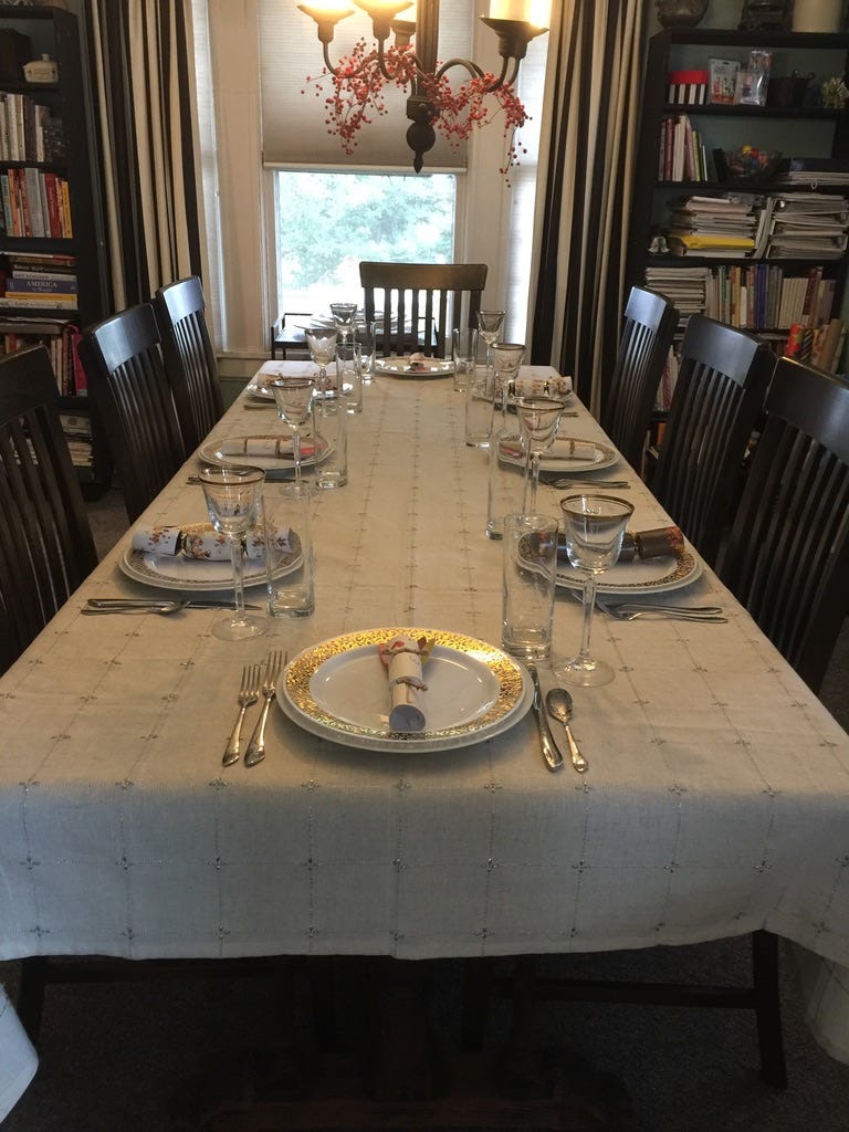 wooden dining room table with place settings