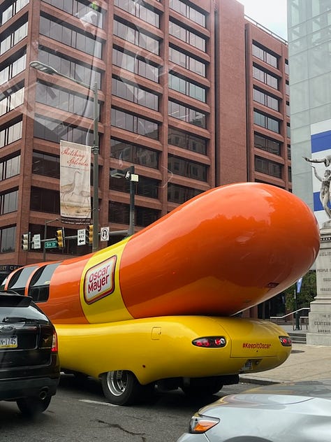 Left to right: 1. Wienermobile at a stoplight 2. Bowl on a table filled with whipped cream and an apple dumpling underneath 3. Four dumplings shaped like birds on cucumber slices and a bright cocktail to the right.