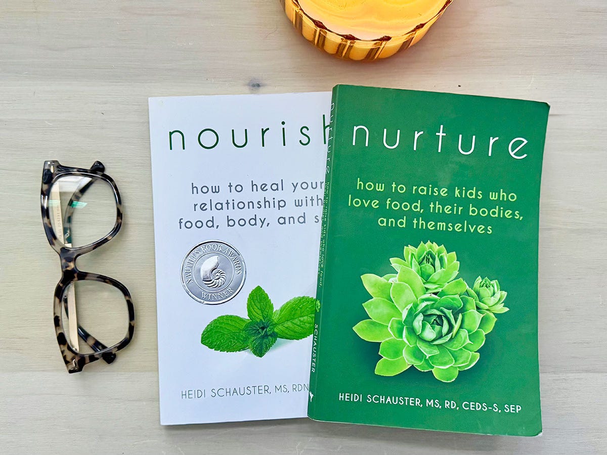 Nourish and Nurture books by Heidi Schauster laying on a desk