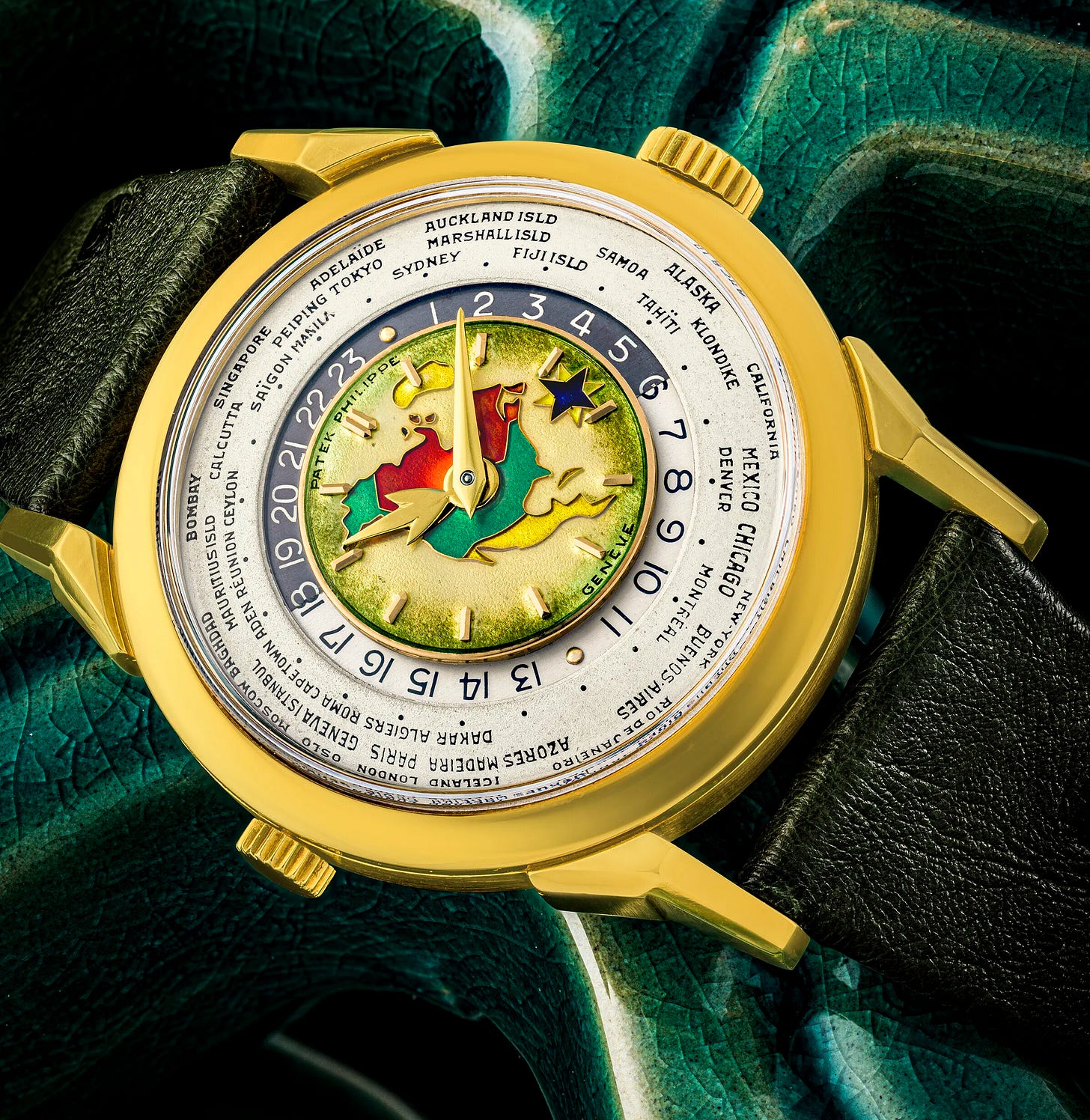 PATEK PHILIPPE. AN EXCEPTIONAL, HISTORICALLY AND HIGHLY IMPORTANT 18K GOLD TWO-CROWN WORLD TIME WRISTWATCH WITH 24 HOUR INDICATION AND CLOISONNÉ ENAMEL DIAL DEPICTING THE NORTH AMERICAN MAP PATEK PHILIPPE. AN EXCEPTIONAL, HISTORICALLY AND HIGHLY IMPORTANT 18K GOLD TWO-CROWN WORLD TIME WRISTWATCH WITH 24 HOUR INDICATION AND CLOISONNÉ ENAMEL DIAL DEPICTING THE NORTH AMERICAN MAP