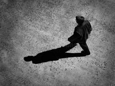 A person walking, casting a shadow behind them.