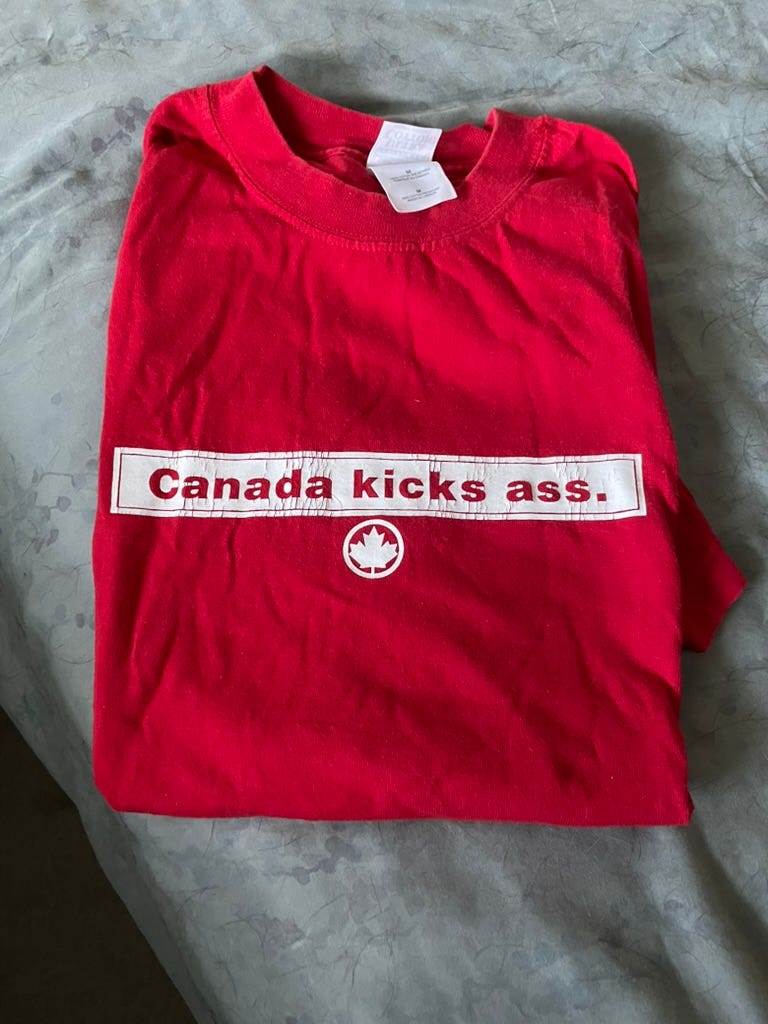 Red t-shirt with the slogan Canada kicks ass
