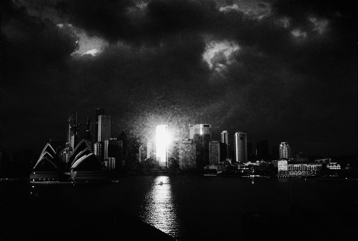 A city skyline with a boat in the water

Description automatically generated