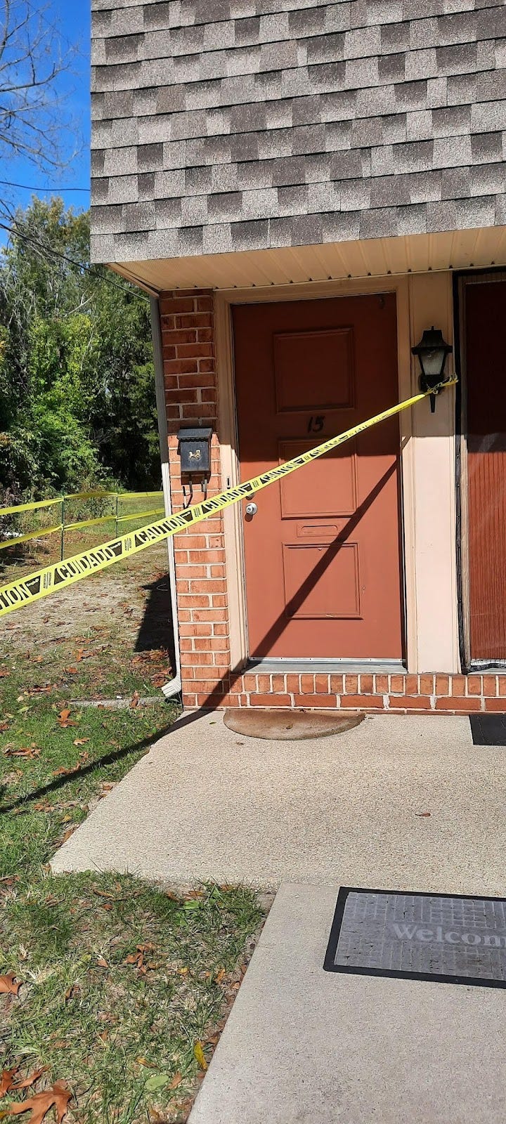 red door with yellow caution tape