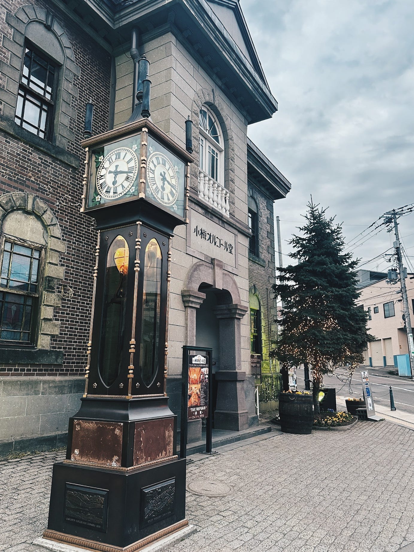 Ornate steam clock in front of the historic brick Otaru Music Box Museum building in Otaru's Meiji-era canal district Ornate steam clock in front of the historic brick Otaru Music Box Museum building in Otaru's Meiji-era canal district