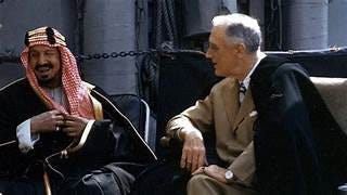 A person in a suit talking to a person

AI-generated content may be incorrect.