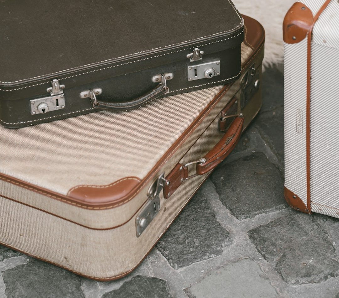 a couple of suitcases sitting on top of a stone floor