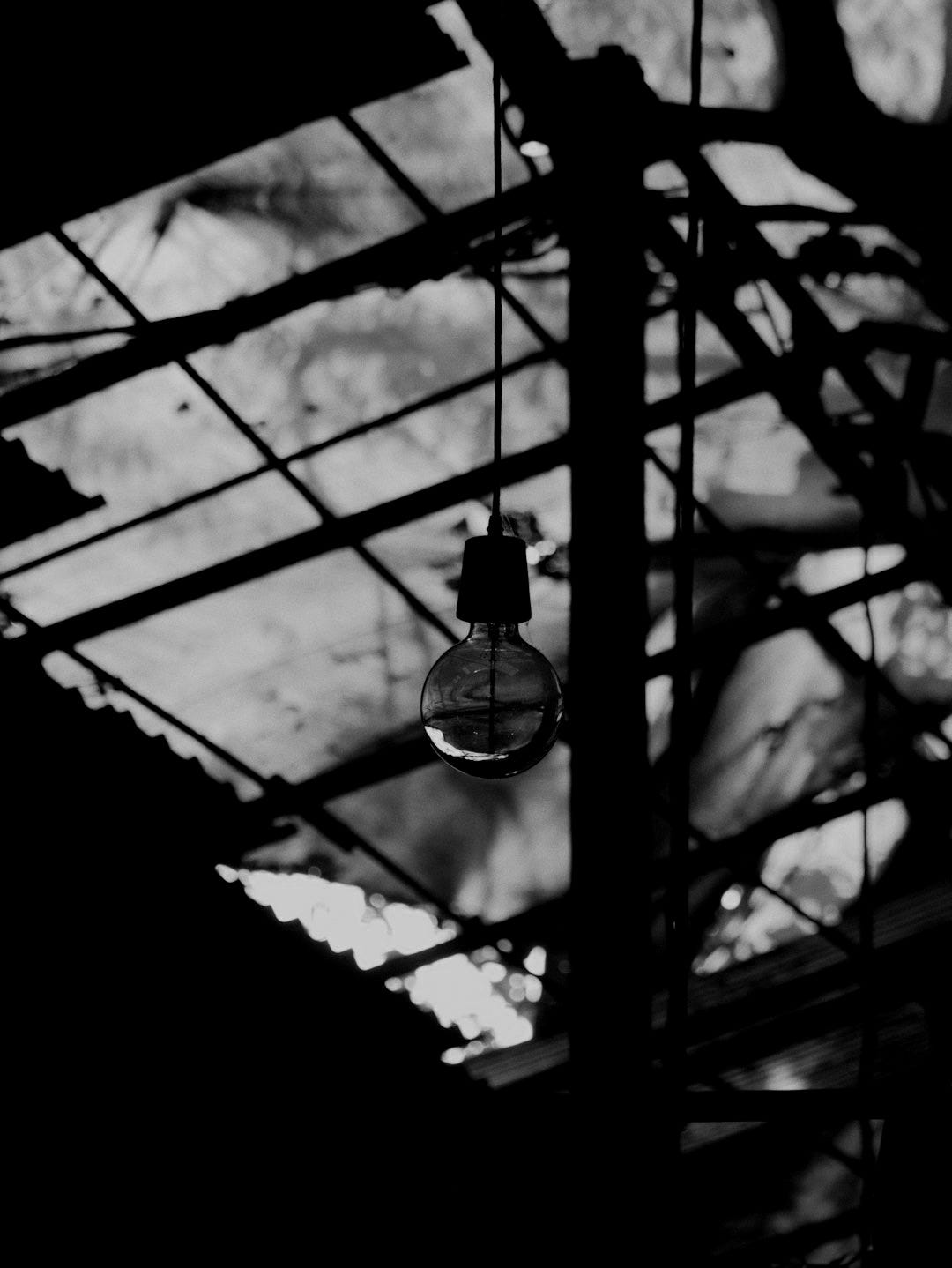 A light bulb hanging from the ceiling of a building