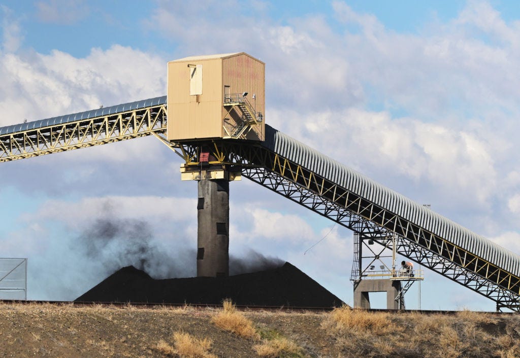 Strong winds carry coal dust from a coal pile at the Comanche Generating Station in Pueblo, Colorado, on February 4, 2025. This coal-fired power plant is a significant source of air pollution and greenhouse gas emissions in the state.