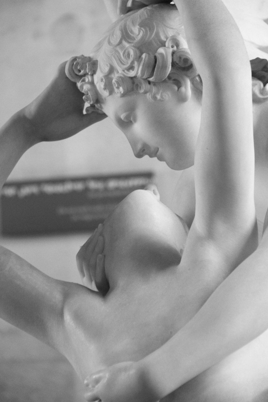 a statue of a naked woman holding her head