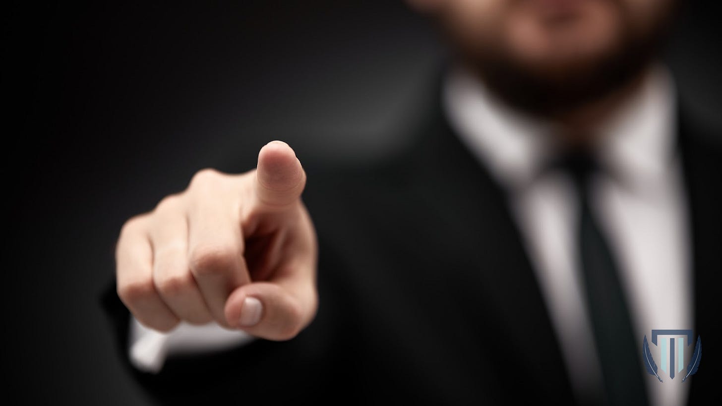 Close up in selective focus of businessman in suit and tie pointing his finger out and forward, on black. I want you, attention, augmented reality, virtual display, copy space concept