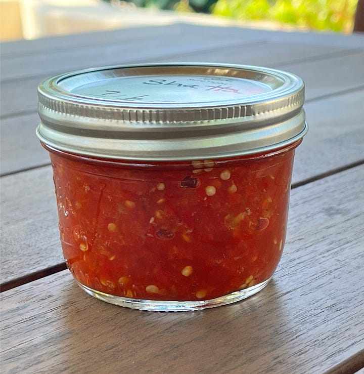 Two jars of shatta, one made from Fresno peppers and one made from jalapeno peppers.