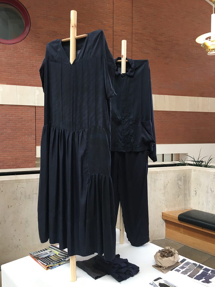 Photos showing the two Phoebe English studio examples of overdyeing print silk samples, with dye test sheet and bag of gall nuts on the table.