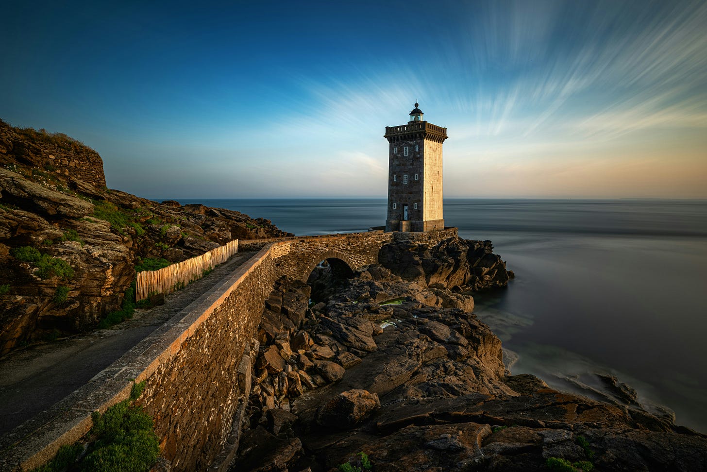 Image of a stone walkway to a stone lighthouse by Evgeni Tcherkasski on Unsplash.