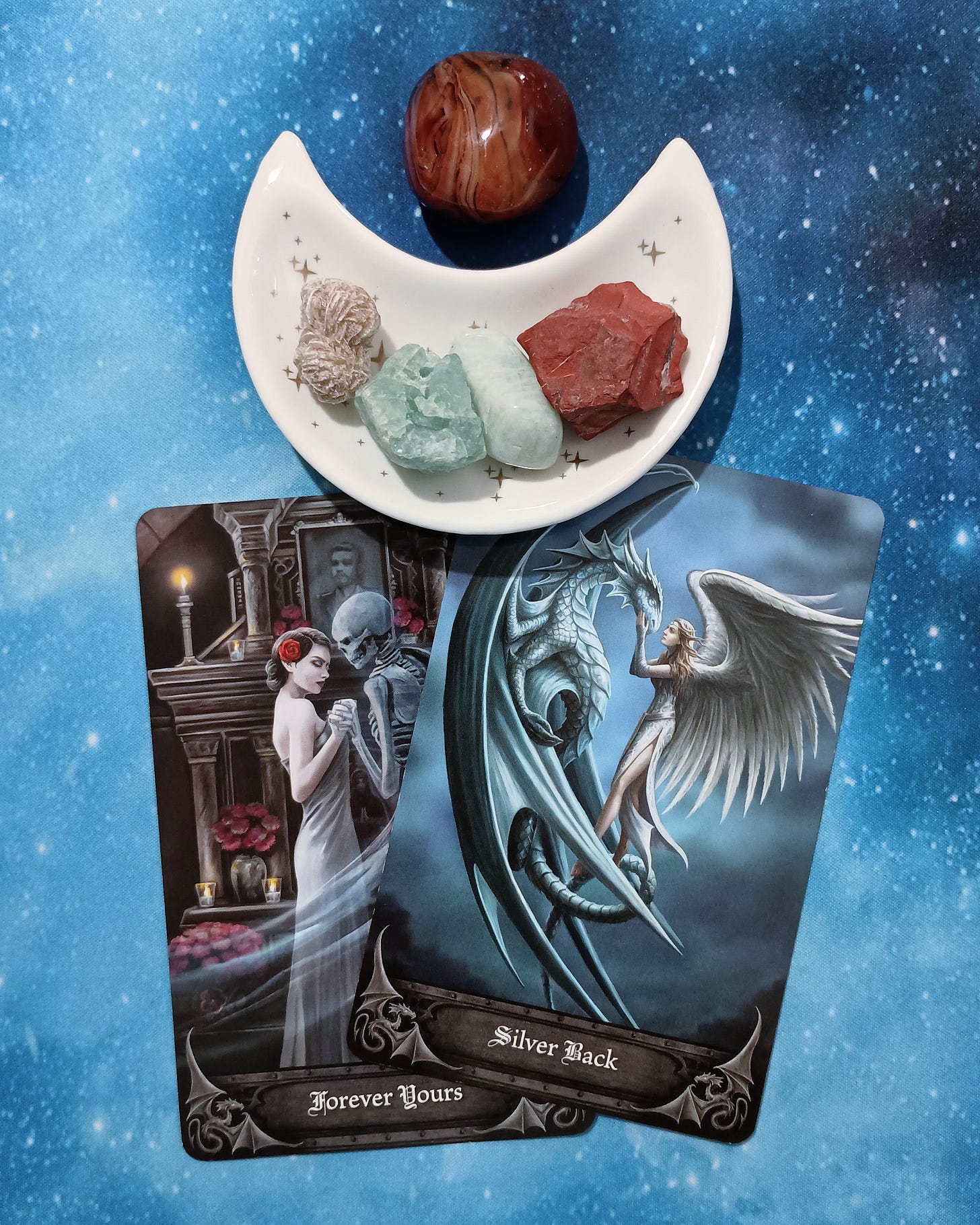 On Love & Building Healthy Relationships: A Message From the Universe 2 Anne Stokes Oracle Cards and crystals on a starry blue background
