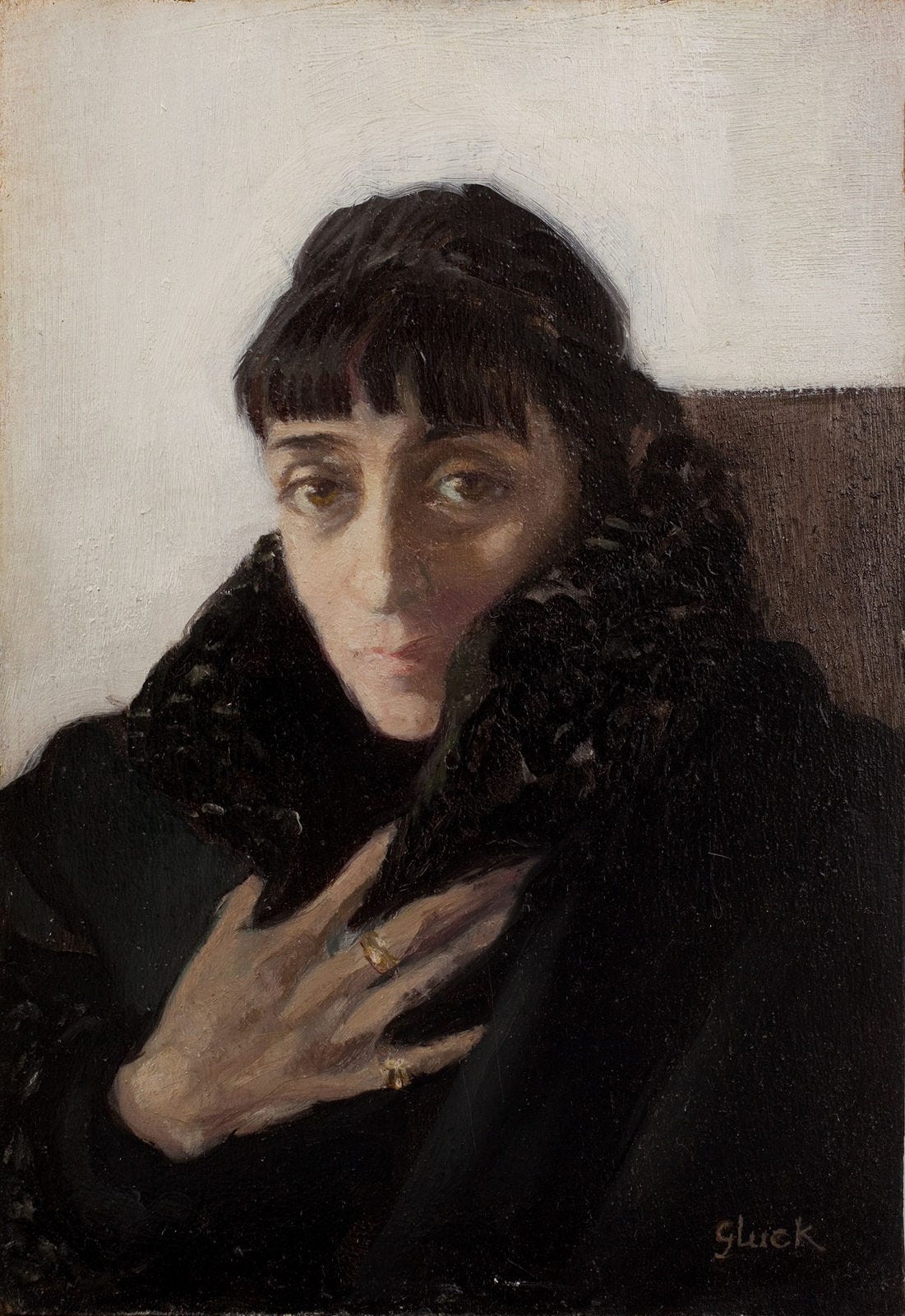 Painting of a white person with short dark hair and bangs, wearing a fur-collared coat. Their expressive eyes convey introspection, with a hand resting on their chest. They are wearing 2 gold ring bands on their hand resting on their chest. The background is white, with a brown square behind them. Gluck's name is in the bottom right corner in brown. Painting of a white person with short dark hair and bangs, wearing a fur-collared coat. Their expressive eyes convey introspection, with a hand resting on their chest. They are wearing 2 gold ring bands on their hand resting on their chest. The background is white, with a brown square behind them. Gluck's name is in the bottom right corner in brown.