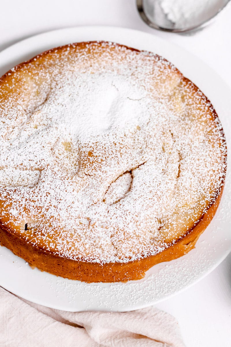 close-up image of Italian apple cake on a white plate. 