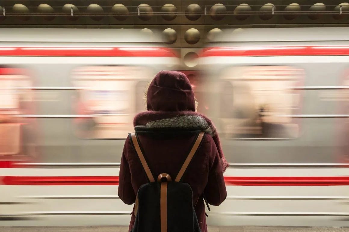 standing woman facing a speeding train standing woman facing a speeding train