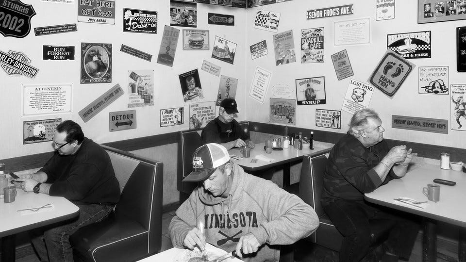 A diner full of people eating alone