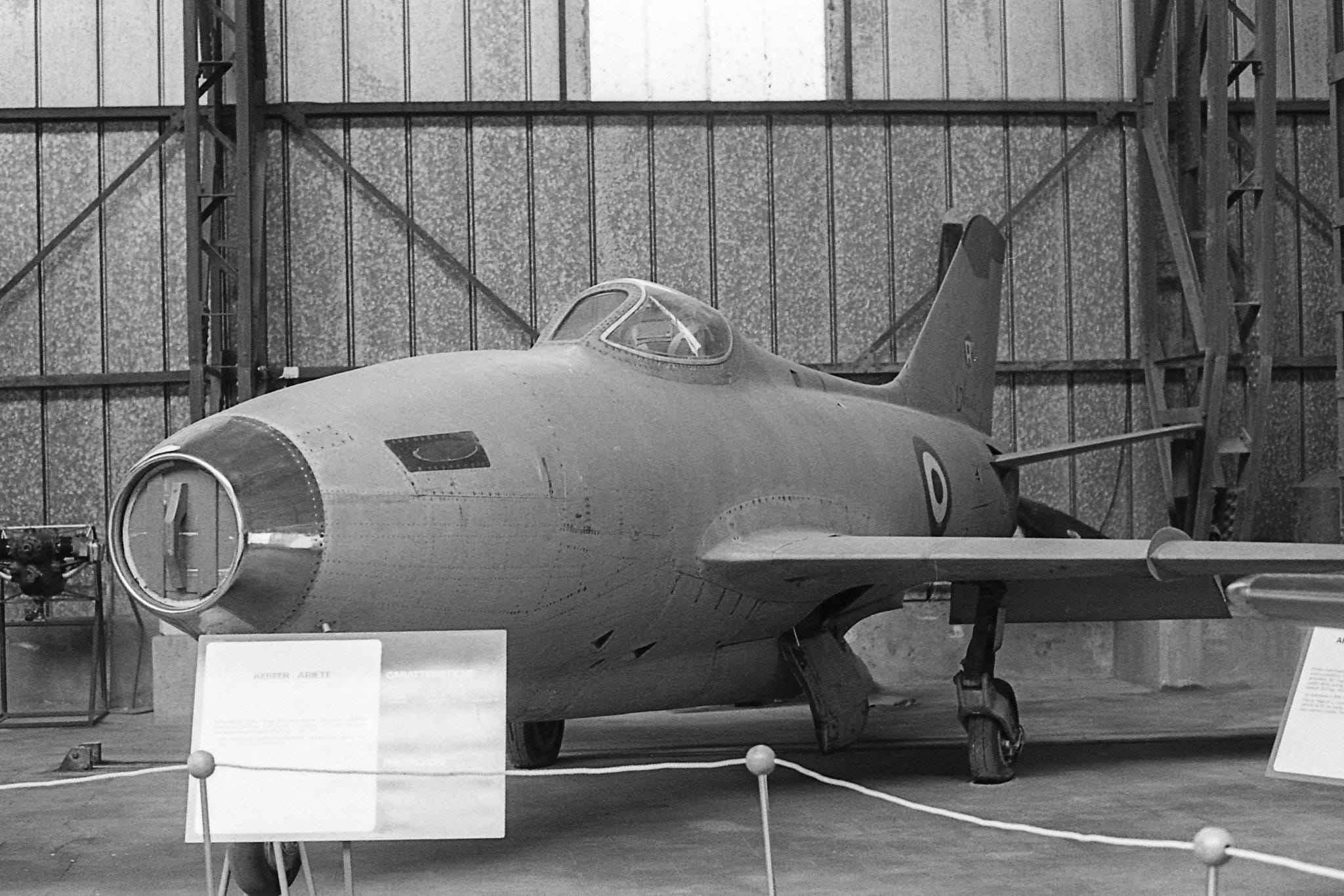 A jet plane in a hangar

AI-generated content may be incorrect.