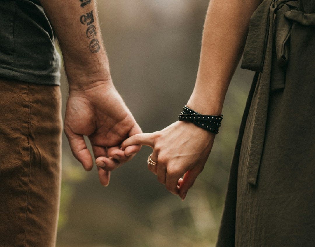 a man and a woman holding hands a man and a woman holding hands