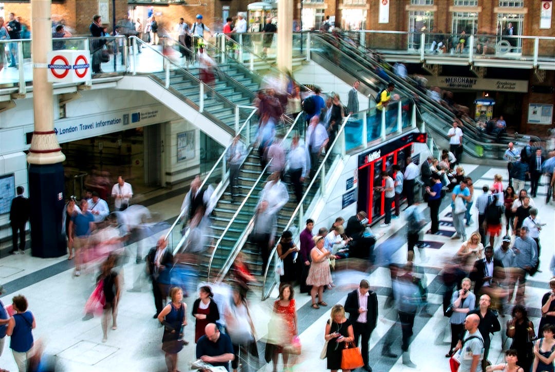 people standing and walking on stairs in mall people standing and walking on stairs in mall