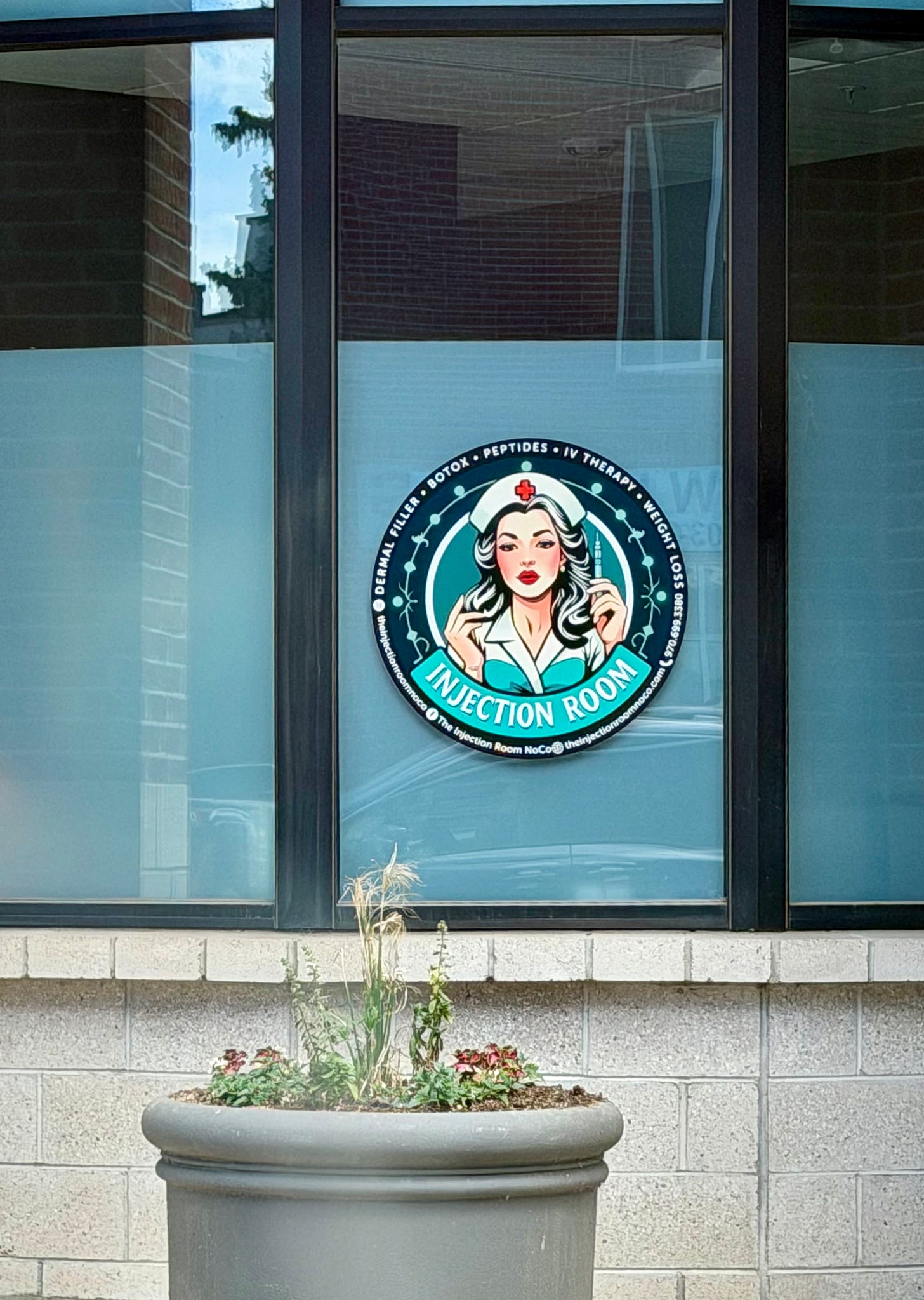A crappy logo with a sexy "nurse" advertising the Injection Room