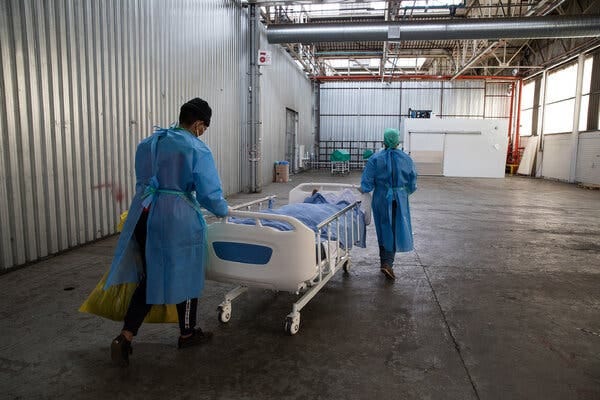 Nurses at a hospital in Neave, South Africa, moved a  patient who died of Covid to a temporary morgue in November 2020. South Africa is the only country in sub-Saharan Africa to record high Covid infection and death rates.