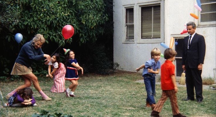 This may contain: a group of children are playing with balloons in the yard while an older man looks on