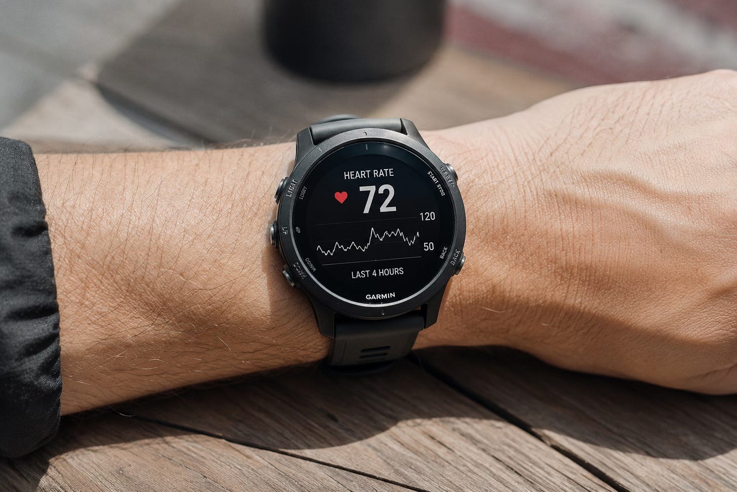 A wrist wearing a smartwatch displaying heart rate data A wrist wearing a smartwatch displaying heart rate data