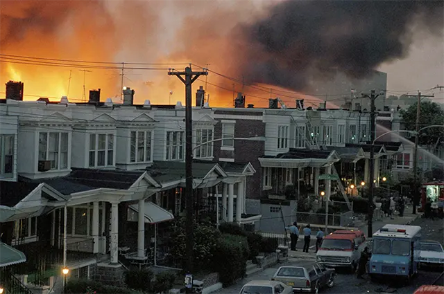 The powerful detonation not only tore through the MOVE compound but also ignited a massive, uncontrollable fire. Firefighters, citing fears of MOVE gunfire, were controversially ordered not to intervene. The powerful detonation not only tore through the MOVE compound but also ignited a massive, uncontrollable fire. Firefighters, citing fears of MOVE gunfire, were controversially ordered not to intervene.