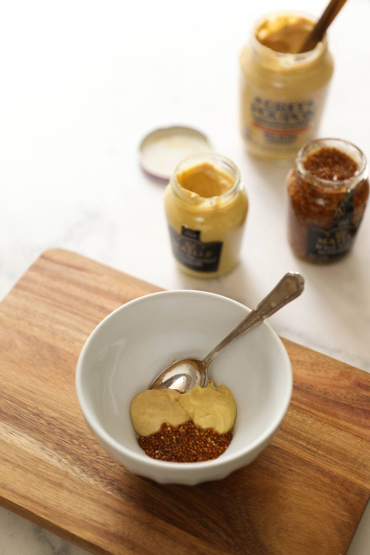 a selection of mustards on a counter top