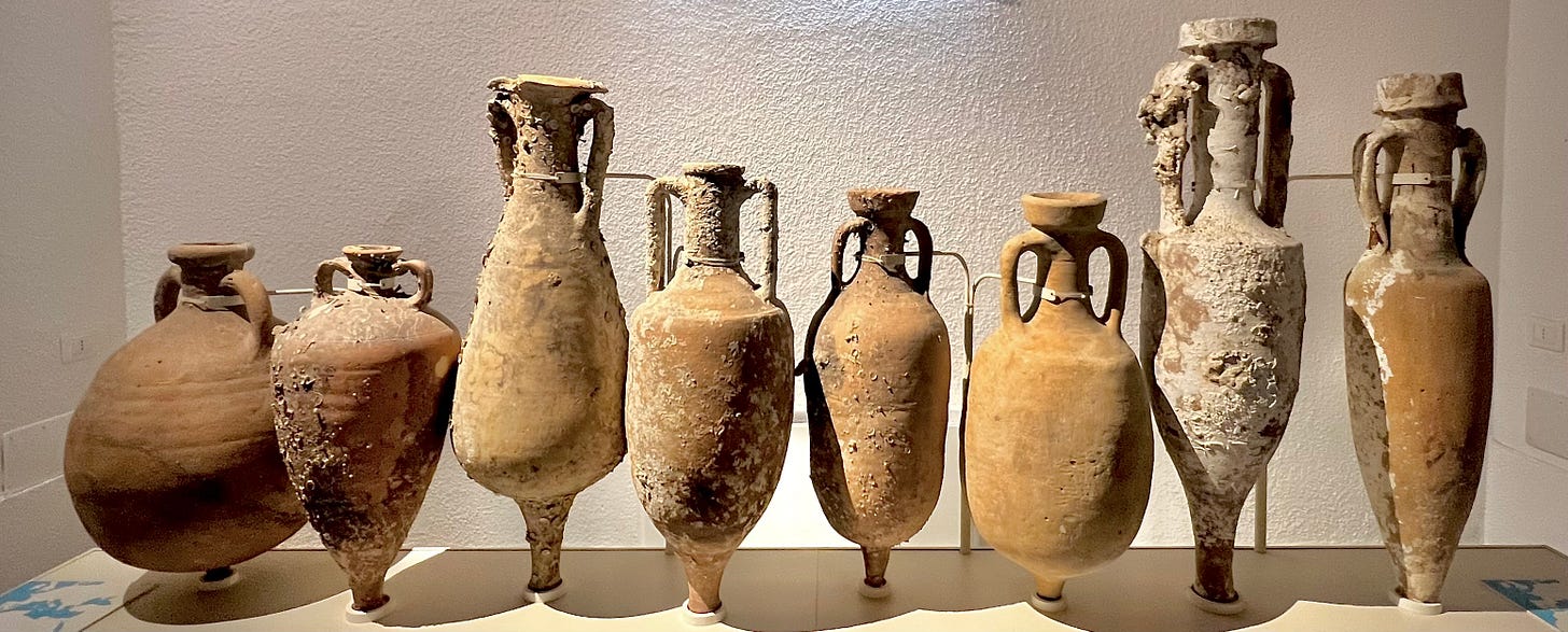 A group of ancient amphoras

Description automatically generated