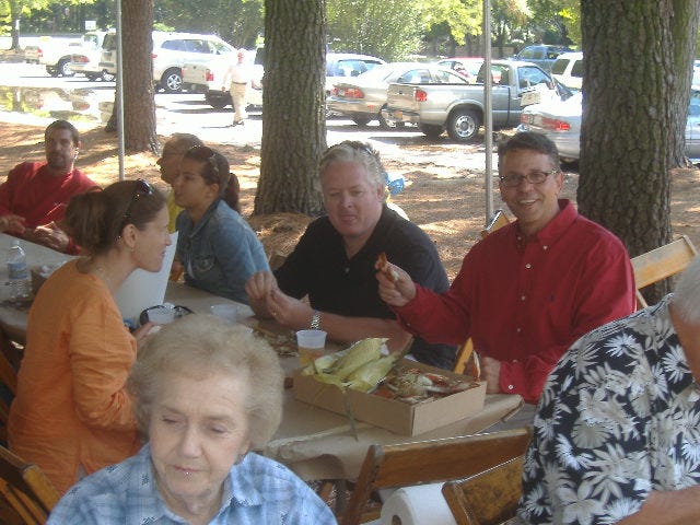 Congressional hopeful John Leo Walter (right, in red) enjoys his lunch with family and friends. Congressional hopeful John Leo Walter (right, in red) enjoys his lunch with family and friends.