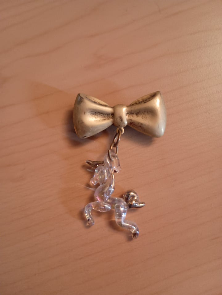 a blue and gold angel and a crystal unicorn with a gold bow
