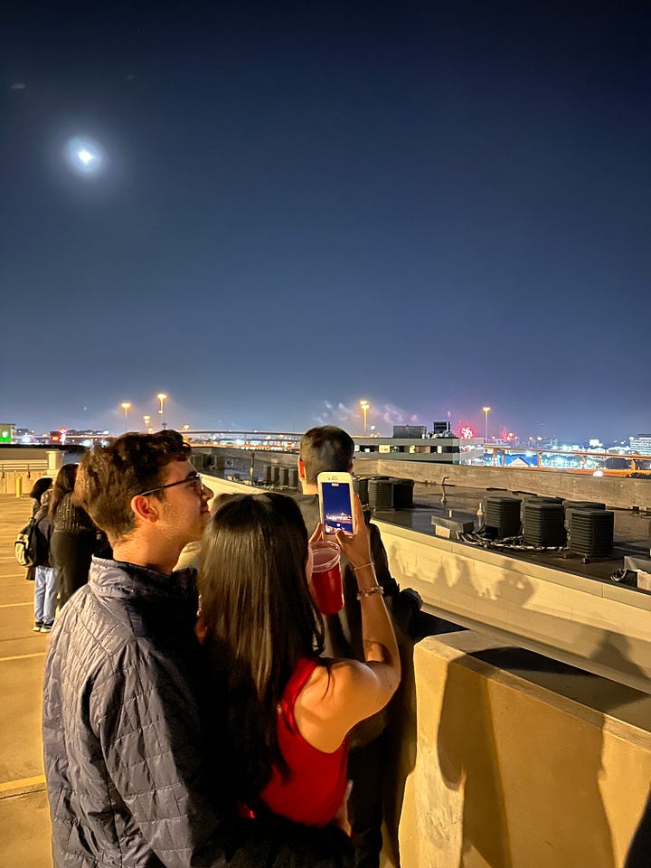 On the left is an image of Jenn and her boyfriend standing on a rooftop while Jenn is taking a photo of the skyline as fireworks erupt on New Years. On the right is an image of Jenn looking off to the left wearing a red and white jacket and headphones.