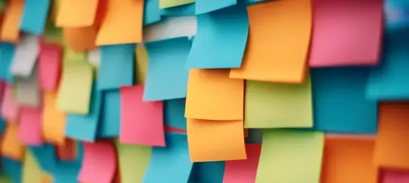 Colorful sticky notes showing student bell-ringer activity responses and quick sketches from classroom entrance routine
