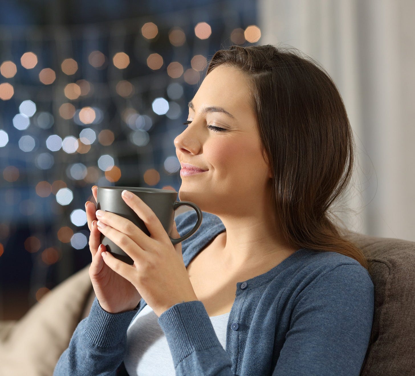 woman enjoying a cup of coffee 