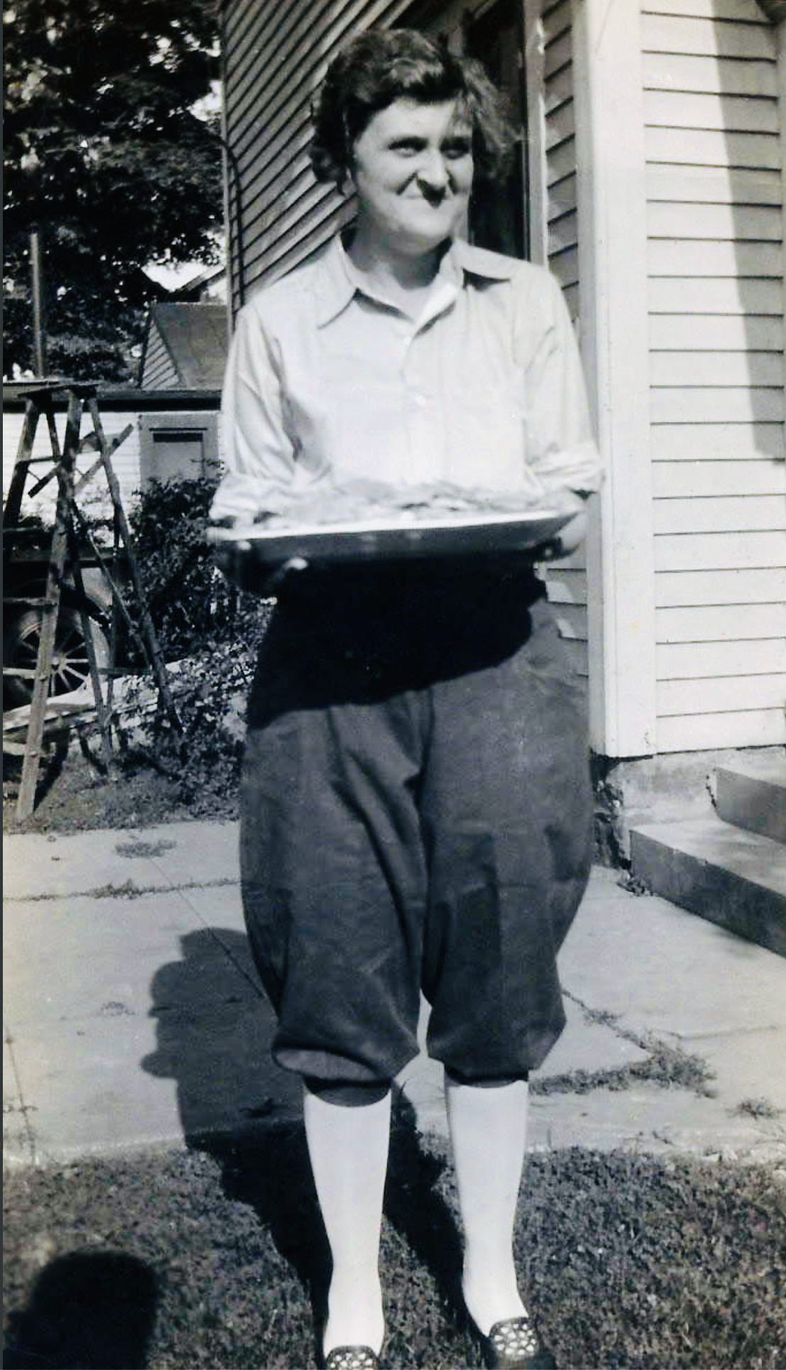 Clara Baker outside her Indiana home - economics teacher, wedding cake baker, and keeper of our ancestral recipe collection. Clara Baker outside her Indiana home - economics teacher, wedding cake baker, and keeper of our ancestral recipe collection.