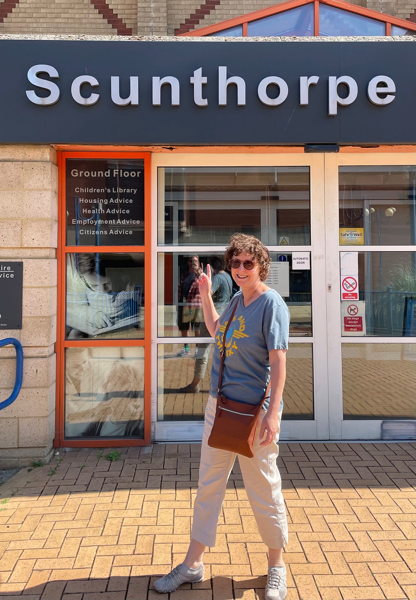 Liz poses in the sunshine outside Scunthorpe Library.