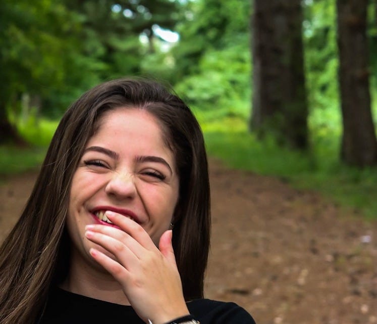 woman in black shirt wearing red beaded necklace woman in black shirt wearing red beaded necklace