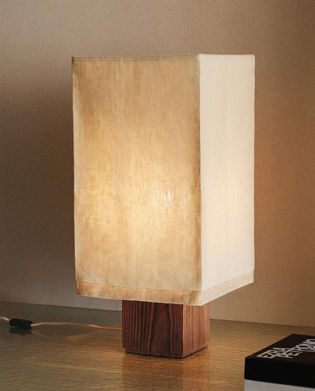 Table lamp with rectangular beige lampshade and brown wooden base. Table lamp with rectangular beige lampshade and brown wooden base.