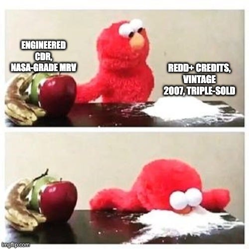Two-panel Elmo meme. Elmo sits at a table between an apple labelled "Engineered CDR, NASA-grade MRV" and a pile of white powder labelled "REDD+ credits, vintage 2007, triple-sold." In the second panel Elmo has face-planted into the powder.