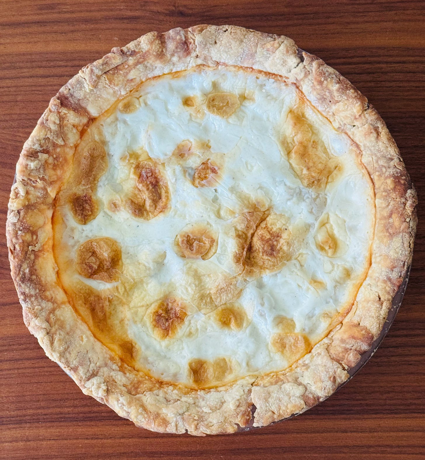 Helen's Old Fashioned Cream Pie fresh from the oven, with a golden caramelized cream surface and flaky pastry crust. Helen's Old Fashioned Cream Pie fresh from the oven, with a golden caramelized cream surface and flaky pastry crust.
