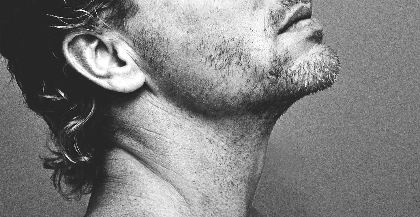 Male model with chin in air, showing lower face and neck only