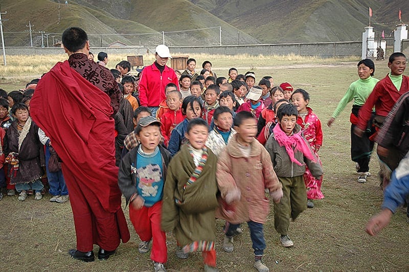 Tulku Hungkar Dorje is seen here, in an undated photo, with dozens of Tibetan children from nomadic families who were provided free education at a school he established. Tulku Hungkar Dorje is seen here, in an undated photo, with dozens of Tibetan children from nomadic families who were provided free education at a school he established.
