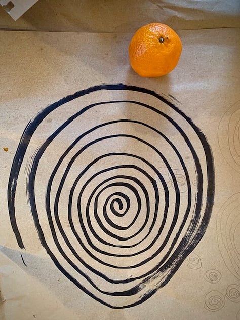 three drawings - a spiral on craft paper, a grid of lines over a cyanotype, intersecting curved lines with coloured shapes