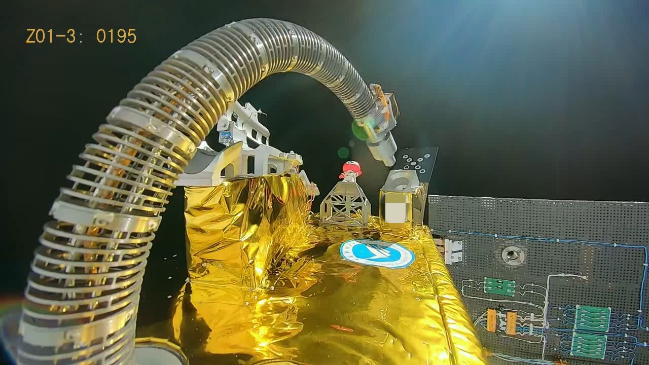 Xiyuan-0’s robotic arm moving towards a target and port on a corner of the satellite in March 2026. Xiyuan-0’s robotic arm moving towards a target and port on a corner of the satellite in March 2026.
