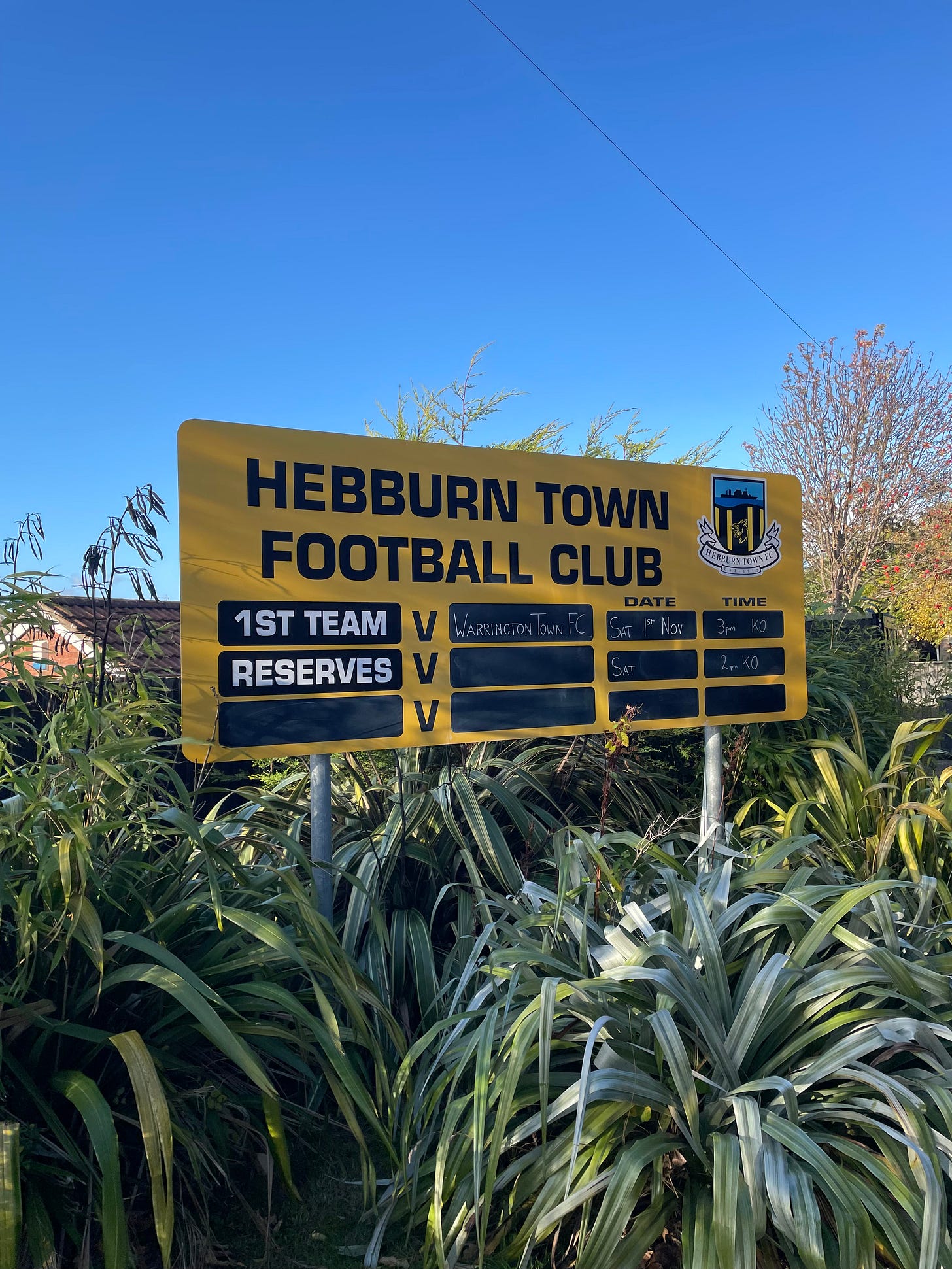 A fixture board showing the details for the match, Hebburn Town vs. Warrington Town