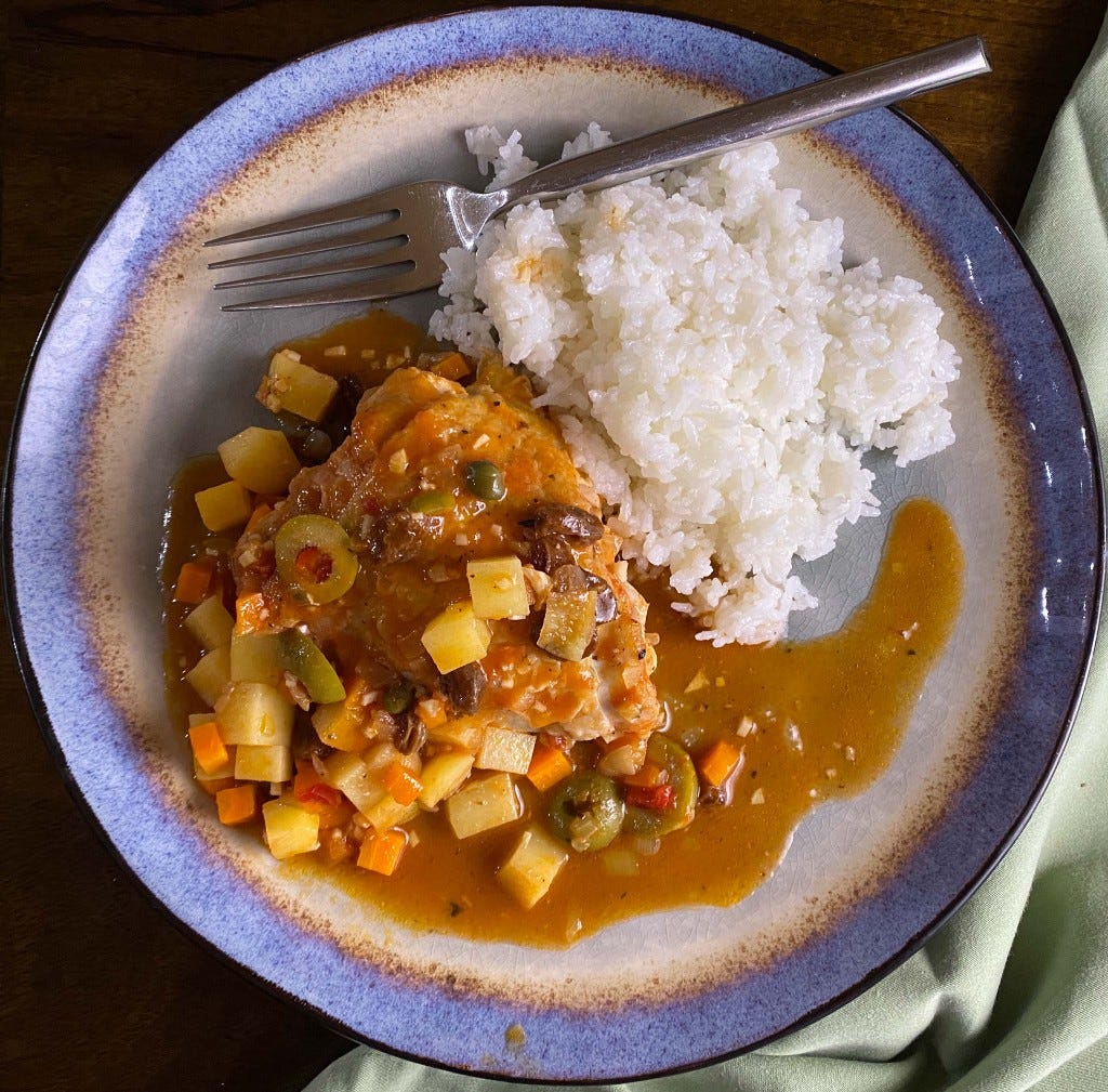 Pollo a la Veracruzana with arroz blanco on a blue and white plate Pollo a la Veracruzana with arroz blanco on a blue and white plate